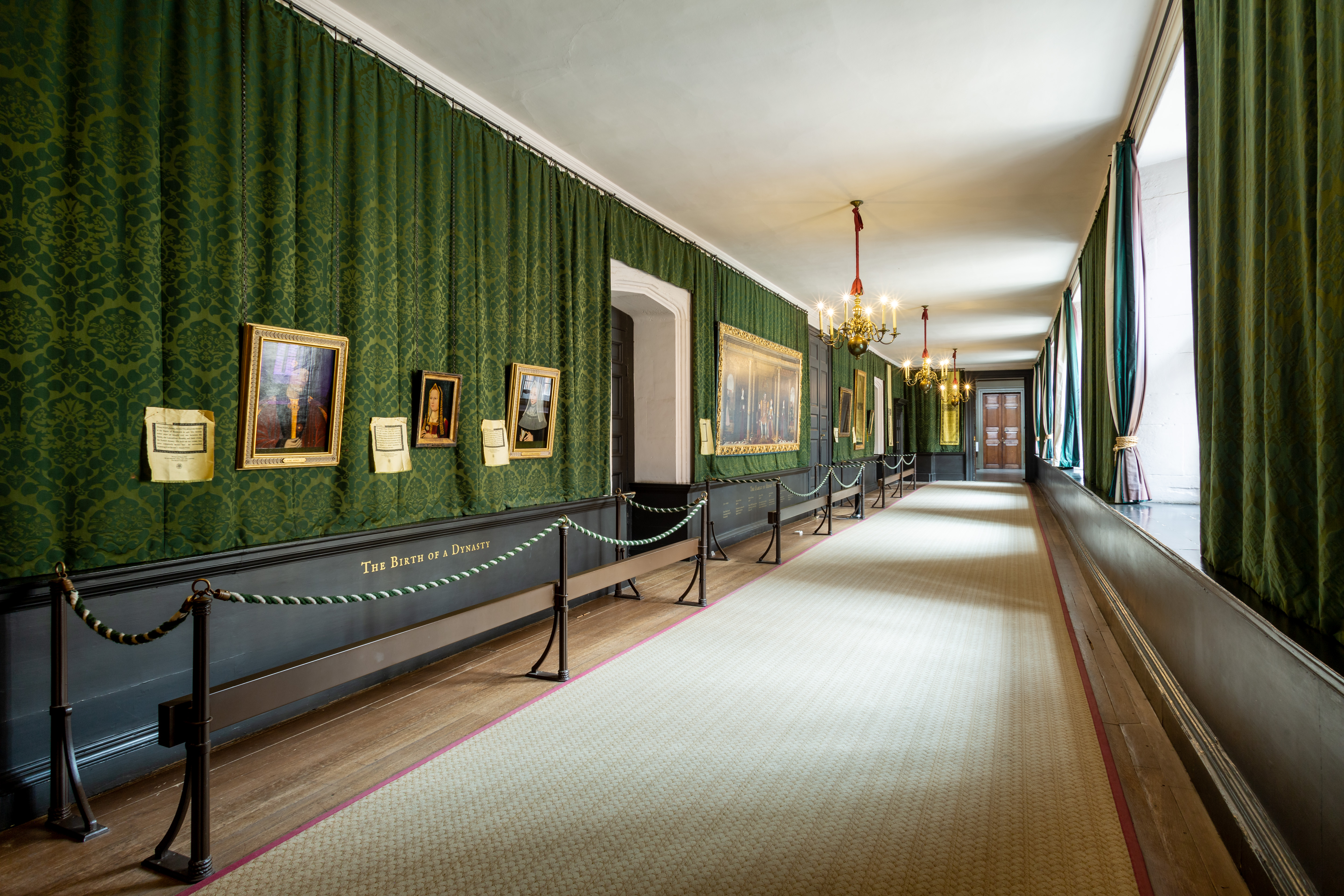 Langer Flur mit grünen Vorhängen und Porträts in London